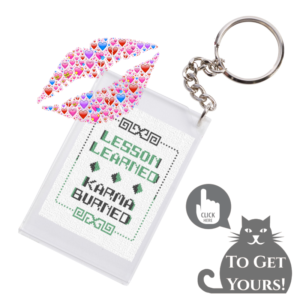 Do you like freebies? The image says, "Click Here to Get Yours". A keychain with a cross stitched "lesson learned karma burned" inside. From Grimalkin Crossing.