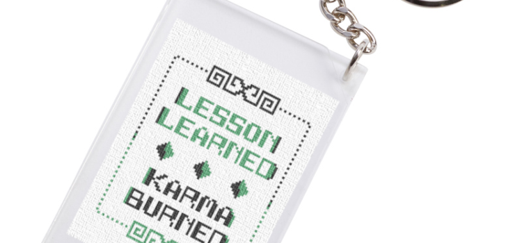Freebies are good karma: Lesson Learned Karma Burned freebie, finished as a keychain fob. Counted cross stitch PDF design from Grimalkin Crossing.