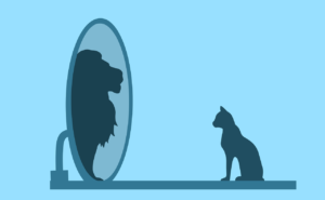 At Grimalkin Crossing, this silhouette image shows a domestic house cat seated on the left. ON the right, a mirror reflects the silhouette of a lion.