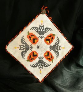 An easy Halloween DIY project! This image features a cross stitch pattern with spooky owls and howling jack-o-lanterns. From Grimalkin Crossing.