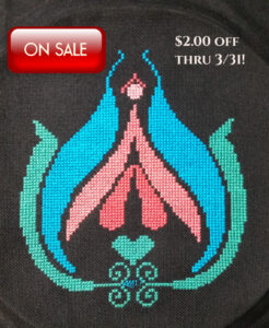 For Grimlkin Crossing's Women's History Month sale. Photo of a cross stitched Clitarita, a stylized human clitoris in five gorgeous pasetl colors. It's on sale at Grimalkin Crossing through 3/31/23.